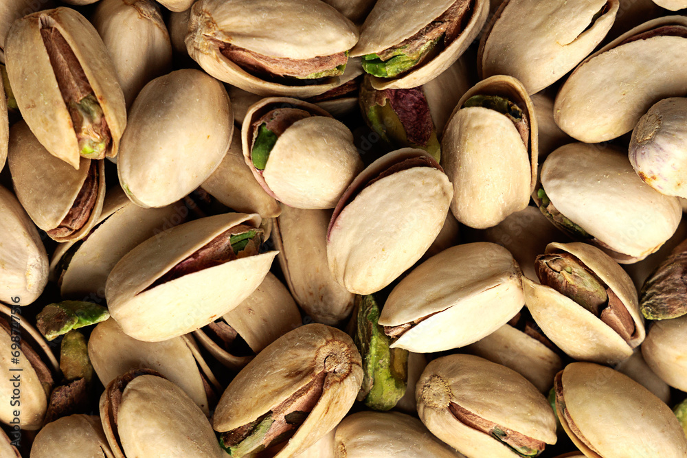 Close-up of pistachios creating a textured background, ideal for food-related themes. Close-up of pistachios creating a textured background, ideal for food-related themes.