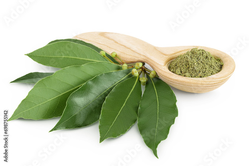 Fresh and ground Laurel leaves in wooden spoon isolated on white background. Green bay leaf