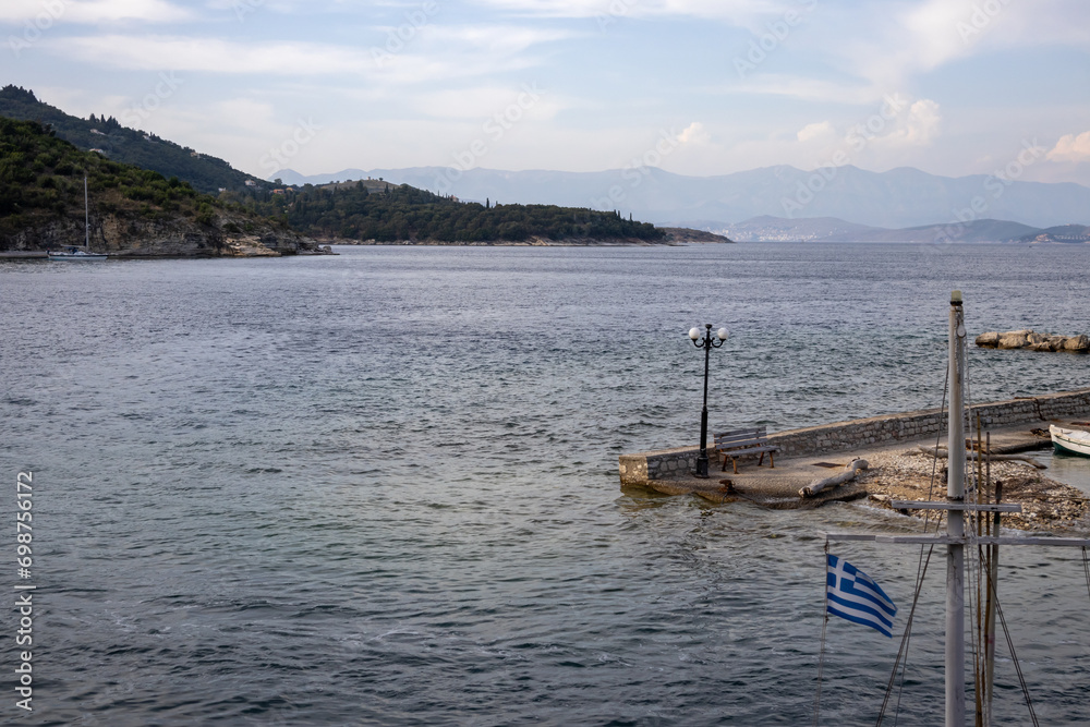 Coast of Corfu island and a greek flag