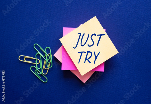 Just try symbol. Orange steaky note with words Just try. Beautiful deep blue background. Business and Just Try concept. Copy space. photo