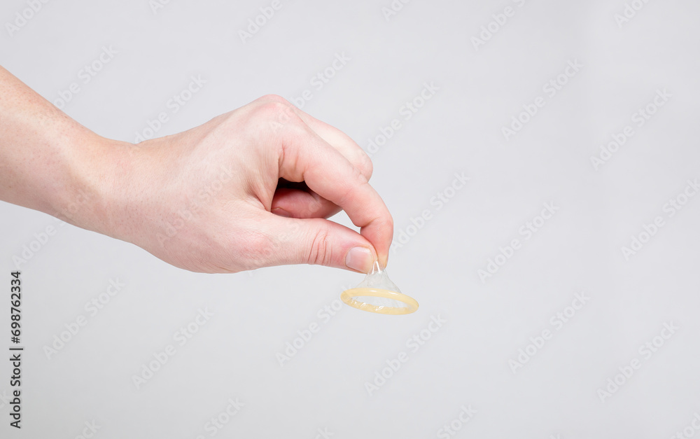 Condom in a man's hand, a means of contraception Condom in a man's hand, a means of contraception