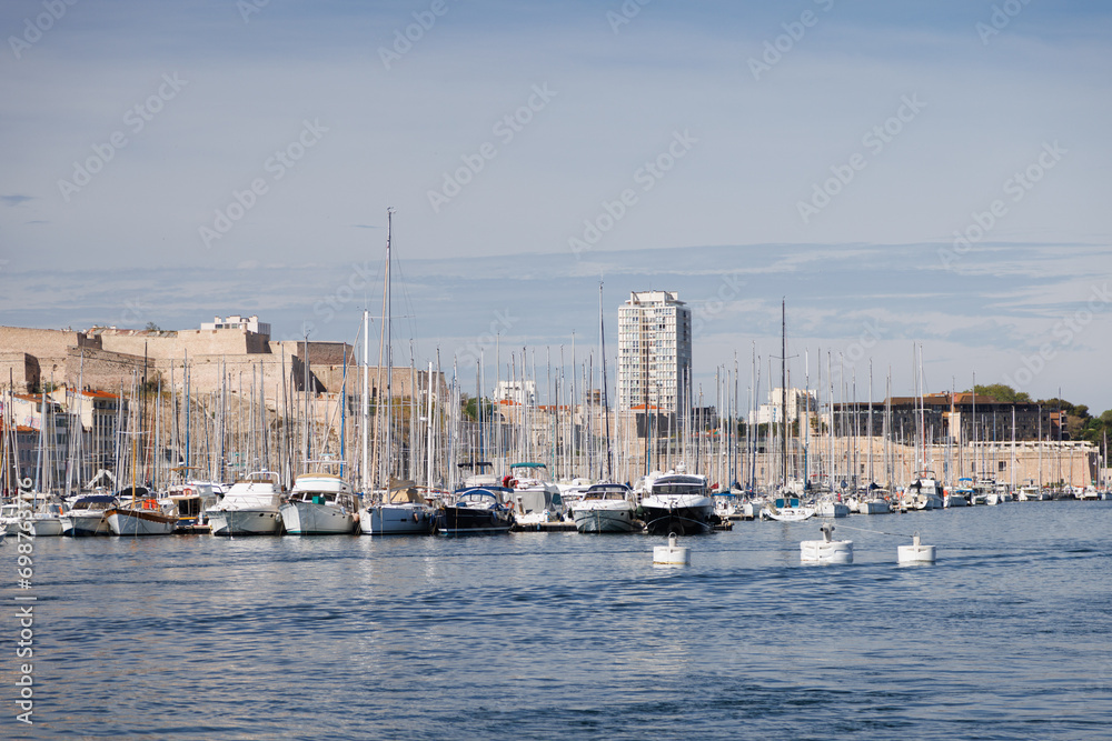 Sailing yachts are docked in the marina of Marseille.