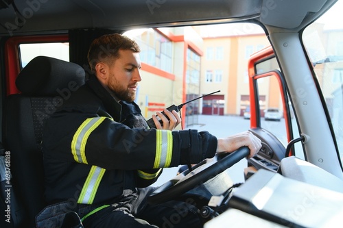 Firefighter drives a emergency vehicle with communication interior view photo