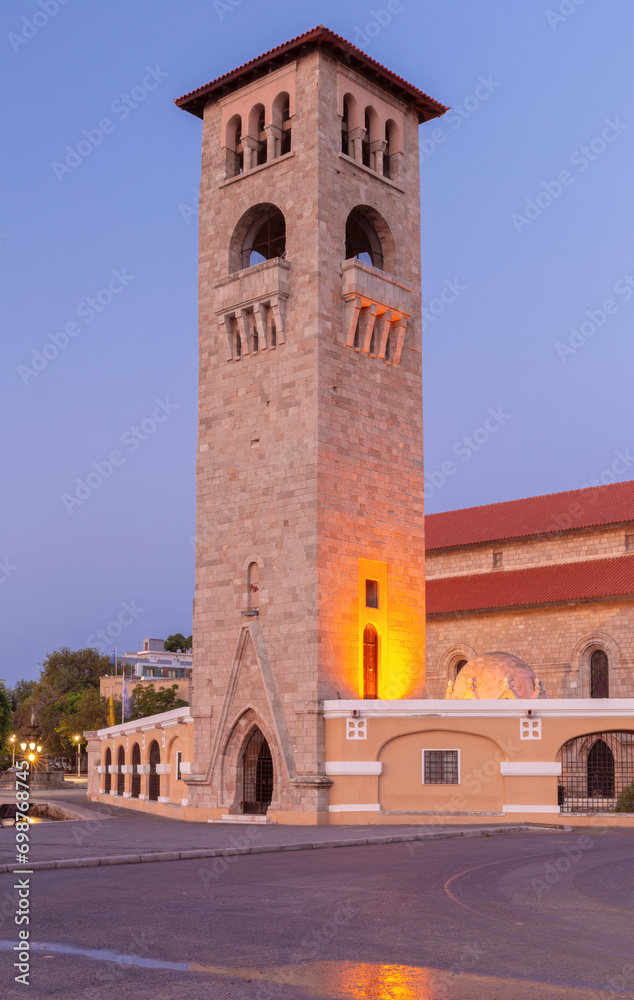 A tall stone tower in the Venetian style on the city embankment at dawn.