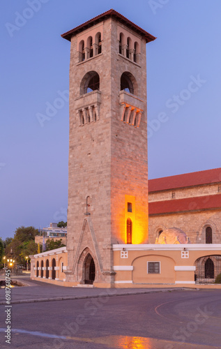 A tall stone tower in the Venetian style on the city embankment at dawn.