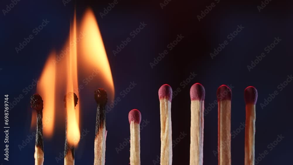 A row of matches where three burning matches blaze and then extinguish when the wind blows. Thick white smoke envelops the matches and rises upwards. Macro shot of the extinguishing matches. A row of matches where three burning matches blaze and then extinguish when the wind blows. Thick white smoke envelops the matches and rises upwards. Macro shot of the extinguishing matches.