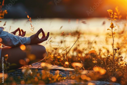 A person sitting in a field practicing yoga. This image can be used to promote relaxation and mindfulness photo