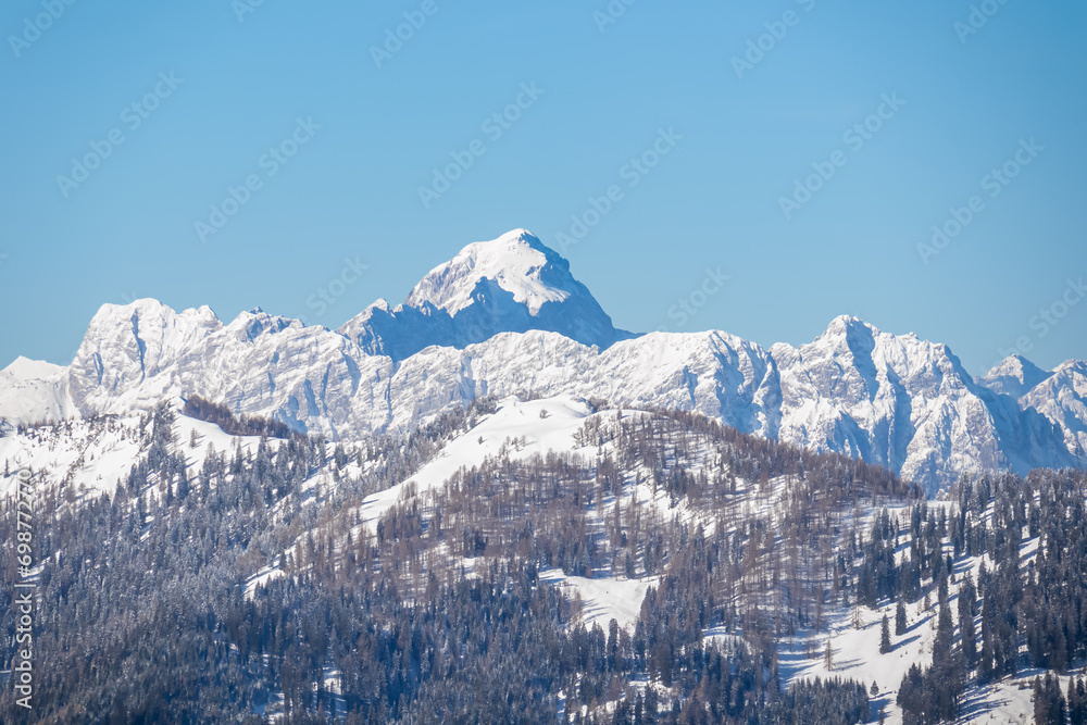 Scenic view of snow covered mountain peak Mangart seen from Ferlacher Spitze in Karawanks, Carinthia, Austria. Winter wonderland in Austrian Alps, Julian Alps and Triglav National Park. Ski touring