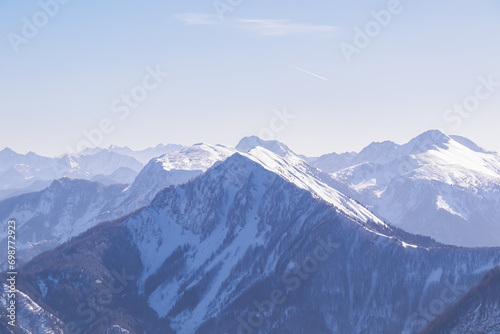 Panoramic aerial view of snow capped mountain ranges of Karawanks, Julian and Kamnik Savinja Alps in Carinthia, Austria. Winter wonderland in remote Austrian Alps. Valley covered with mystical fog © Chris