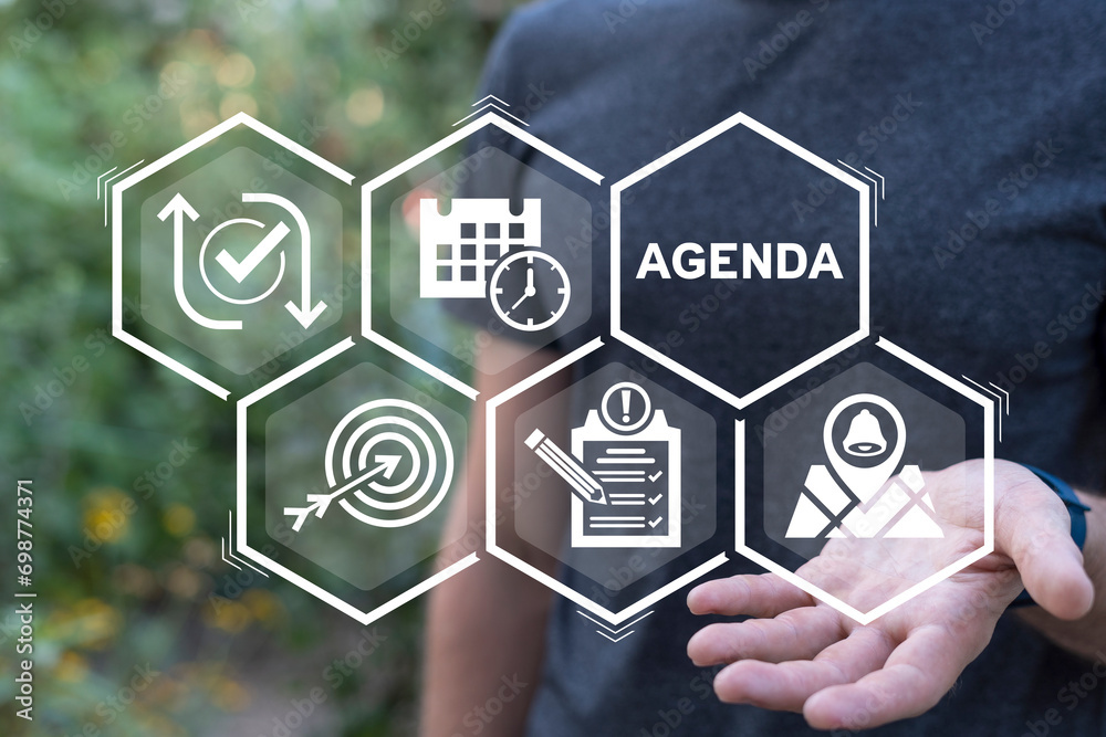 Man using virtual interface sees word: AGENDA. Agenda meeting appointment activity information business concept. Planner, calendar activities and tasks.
