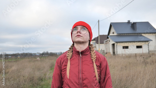 Portrait of a teenage girl in glasses wearing red clothes outside in the fall. © Довидович Михаил