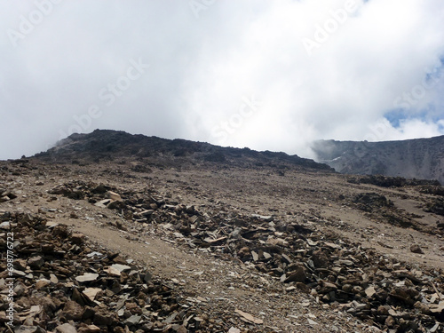 A large desert valley in the mountains with piles of stones. Desert landscape