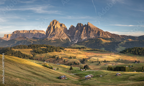 Obraz na płótnie Stunning sunset at Langkofel with colorful sky at Italian Dolomites. Impressive Sassolungo mountain with Alpine lodges.
w salonie
