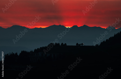 Obraz na płótnie Dark red sky at Italian Dolomites with mountain peaks in distance. Twillight hour at Italian Alps. w salonie