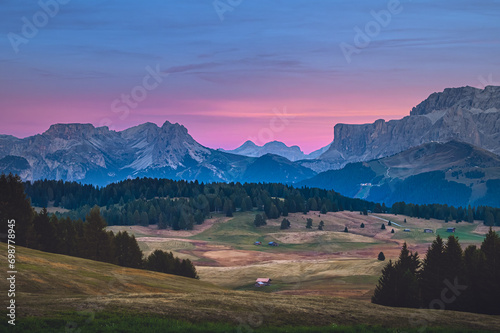 Obraz na płótnie Stunning sunset at Langkofel with colorful sky at Italian Dolomites. Impressive Sassolungo mountain with Alpine lodges.
w salonie