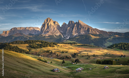 Obraz na płótnie Stunning sunset at Langkofel with colorful sky at Italian Dolomites. Impressive Sassolungo mountain with Alpine lodges.
w salonie