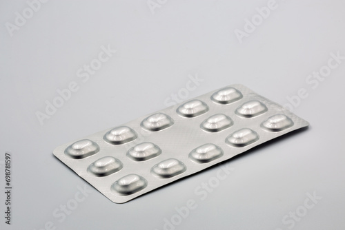 Medical tablets in metal foil blisters closeup