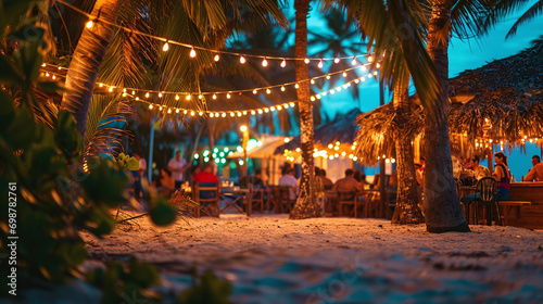 A tropical beach bar in the Caribbean with bokeh lights strung between palm trees as vacationers enjoy refreshing cocktails and live music  photo