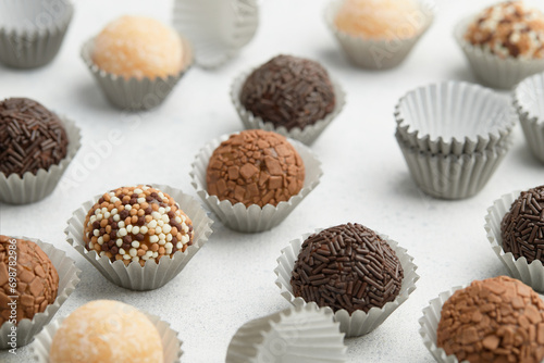 Typical Brazilian sweet brigadeiro. Assorted flavors of candies on a white table. Pattern