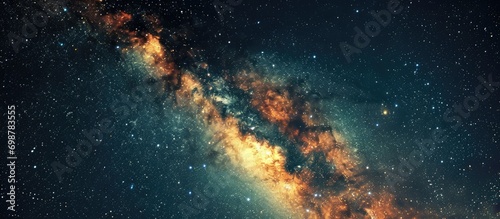 Long exposure photo of Milky Way galaxy with stars and space dust, night sky with grainy background.