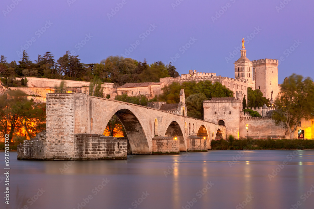 Famous medieval Saint Benezet bridge and Palace of the Popes during blue hour, Avignon, France