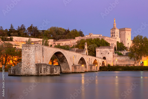 Famous medieval Saint Benezet bridge and Palace of the Popes during blue hour, Avignon, France