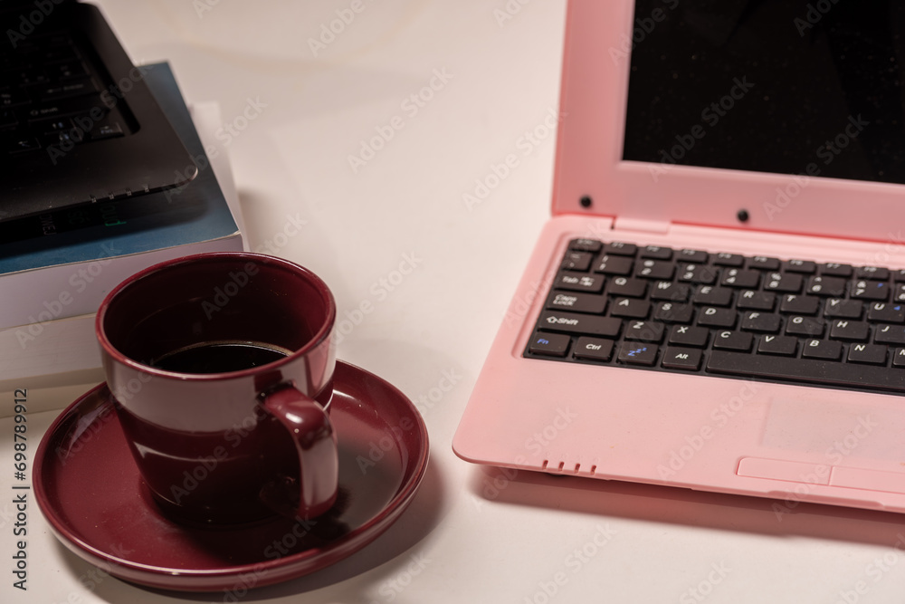 Pink notebook with coffee on the white background Pink notebook with coffee on the white background