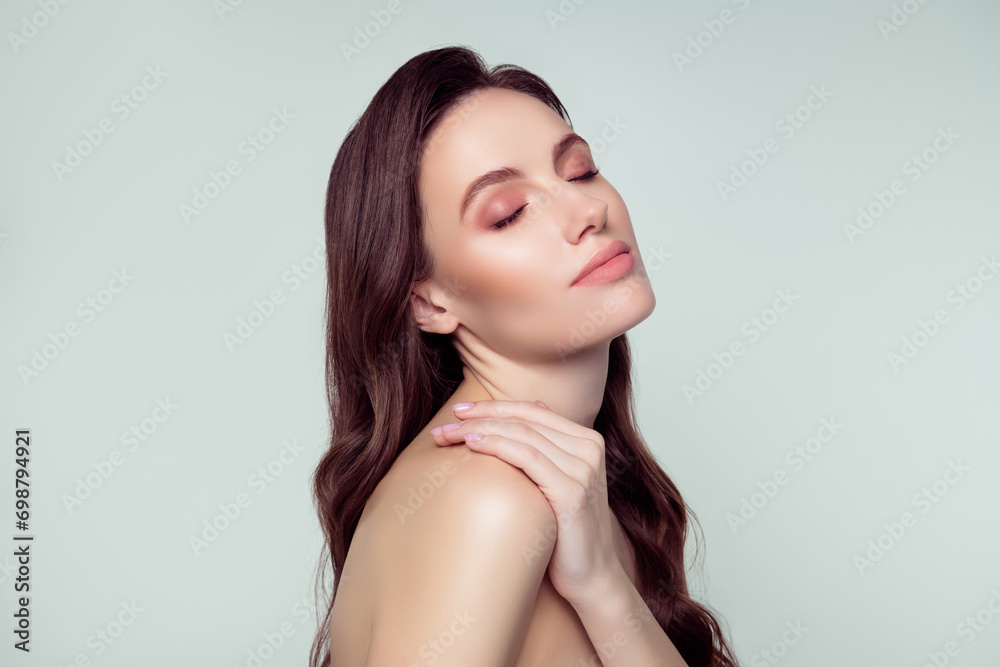 Photo portrait of lovely young lady touch shoulder enjoy procedure spa salon isolated on light gray color background Photo portrait of lovely young lady touch shoulder enjoy procedure spa salon isolated on light gray color background