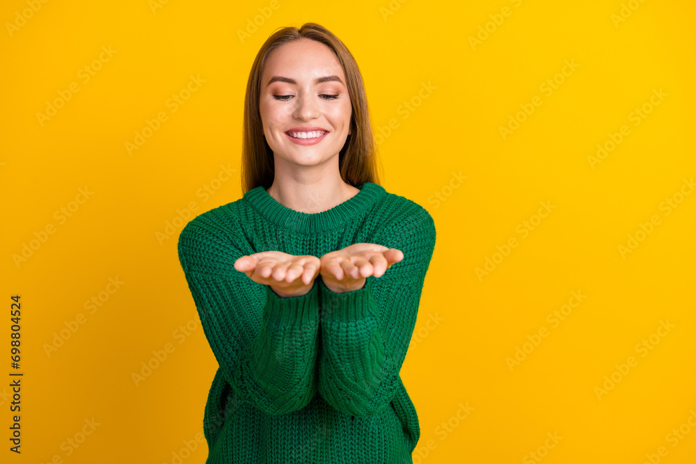 Portrait of young smiling girl model enjoy winter holidays vibes with xmas decoration holding arms isolated on yellow color background Portrait of young smiling girl model enjoy winter holidays vibes with xmas decoration holding arms isolated on yellow color background