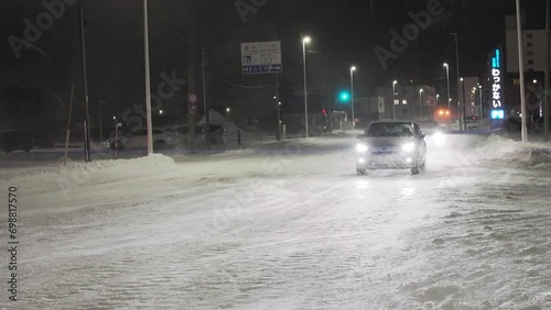 Hokkaido, Japan - December 20, 2023: Blizzard or snowstorm on a street in Wakkanai, Hokkaido, Japan
 photo