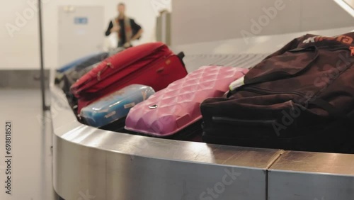 Suitcase or luggage with a circulating conveyor belt in luggage at an international airport. Baggage carousel. Luggage belt with tourists' bags