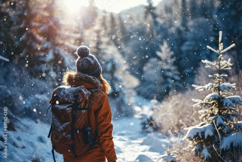 Adventurous woman backpacking in a snowy mountain landscape, embracing the winter wonderland.