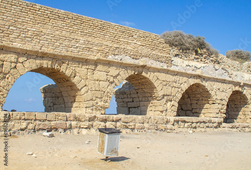 A section of the magnificent ancient Roman aquaduct, where it crosses the Mediterranean beach at Ceaserea Maritima in Israel photo