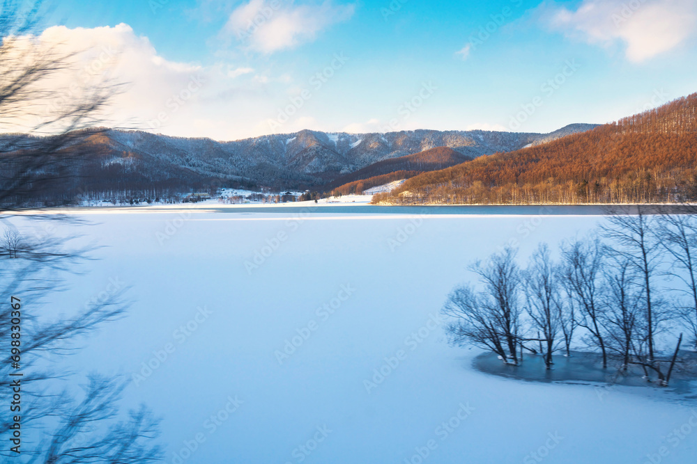 Hokkaido, Japan - December 23, 2023:  Lake Kanayama viewed from a train of Furano Line in Hokkaido, Japan