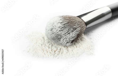 Makeup brush with rice loose face powder on white background