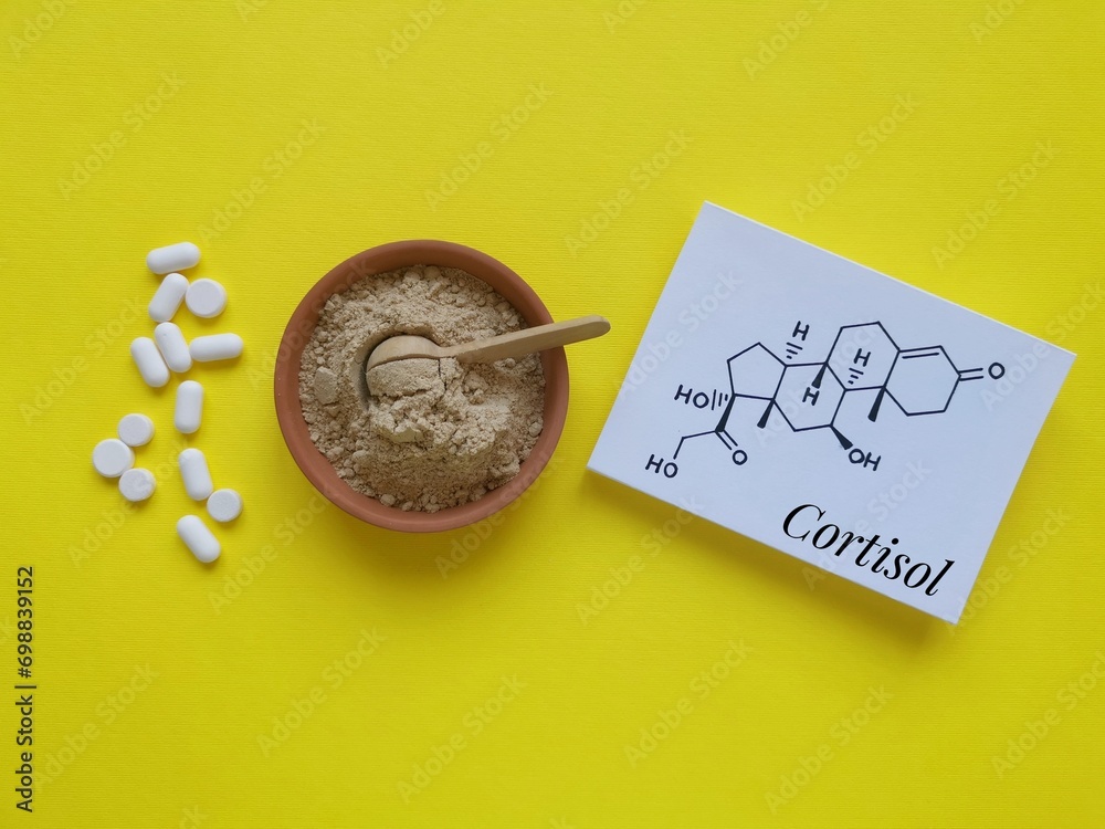 Structural chemical formula of cortisol (a steroid hormone) with white pills and ashwagandha powder. Cortisol is a stress hormone. Ashwagandha food supplements for stress and anxiety, medical concept. - obrazy, fototapety, plakaty 