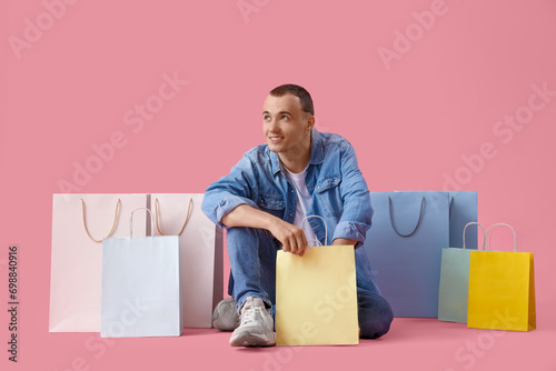 Young man with shopping bag...