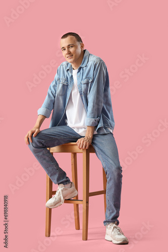Young man sitting in chair ...