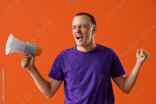 Angry young man with megaph...