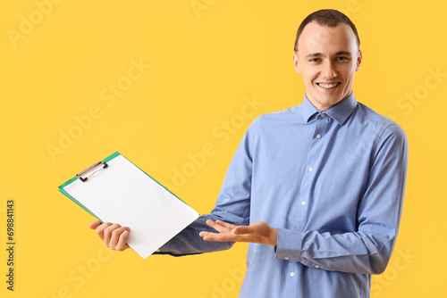 Young man with clipboard on...