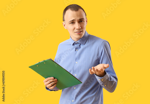 Confused young man with cli...