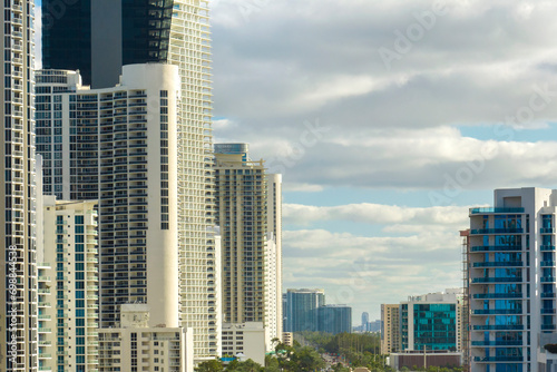 High angle view of Sunny Isles Beach city with expensive highrise hotels and condo buildings on Atlantic ocean shore. American tourism infrastructure in coastal southern Florida