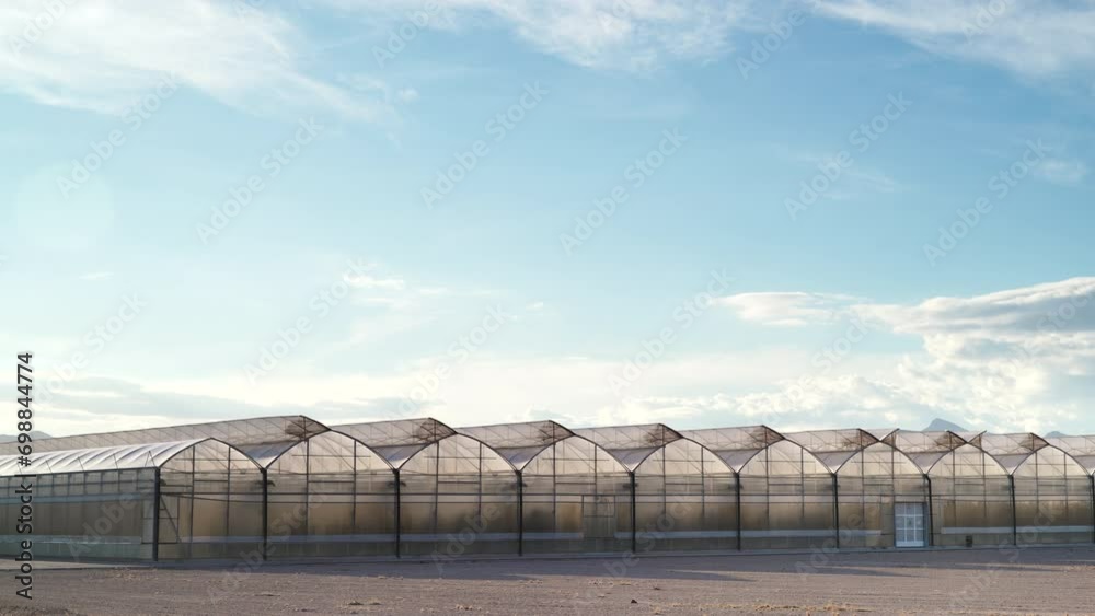Time lapse of clouds moving over spanish coast landscape with big commercial glass greenhouses. Industrial agriculture. Murcia region, Spain. Time lapse of clouds moving over spanish coast landscape with big commercial glass greenhouses. Industrial agriculture. Murcia region, Spain.