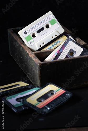 Rustic box with several audio cassettes from the 80's.