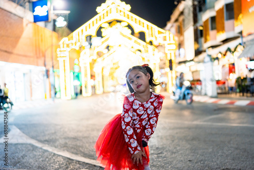 child in city with Christmas lights