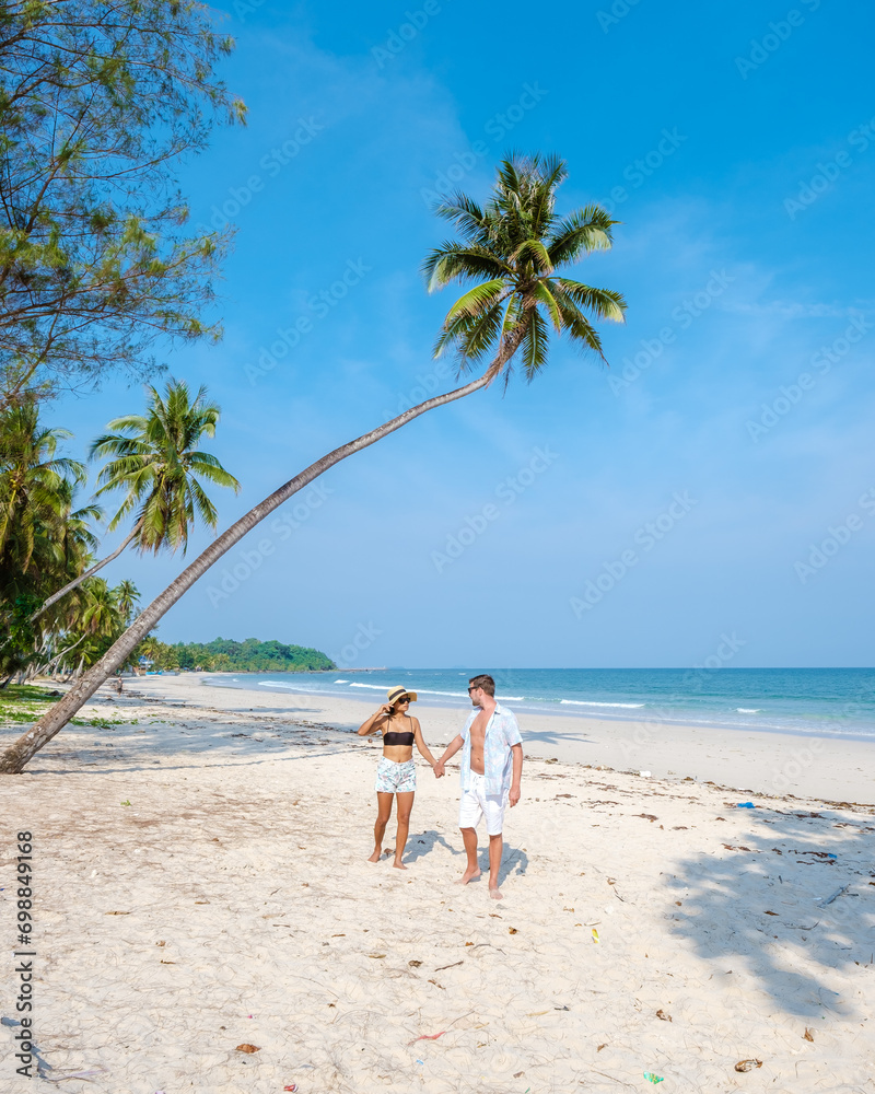 couple on vacation in Thailand, Chumpon province, white tropical beach with palm trees
