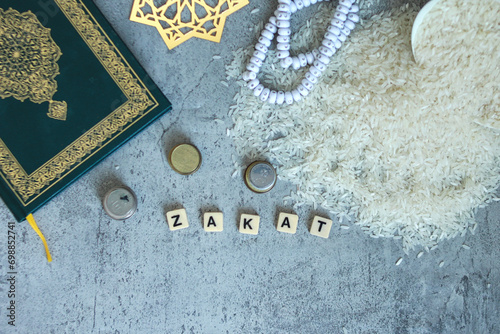 Wallpaper Mural Rice grain, stacked coins, holy Quran and wooden blocks with word Zakat on grey background.  Torontodigital.ca