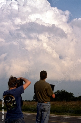 Storm chasers in the field viewing a pre-tornadic thunderstorm. © Michael