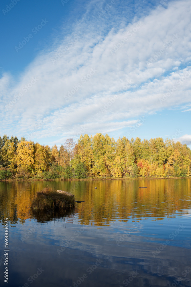 Clouds and blue sky over the river with beautiful autumn colors