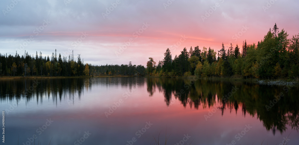 Fototapeta premium Red evening clouds over a small wilderness lake in Northern Finland